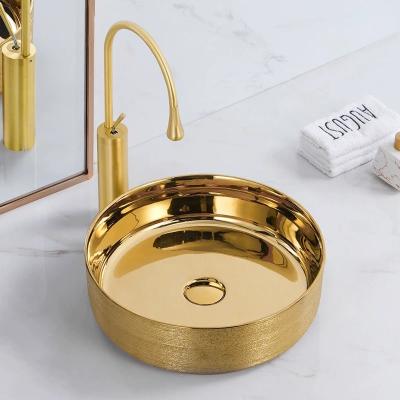 China Modern Exterior Electroplate Design Inside Glossy White Round Bathroom Sink Ceramic Hand Art Basin for sale