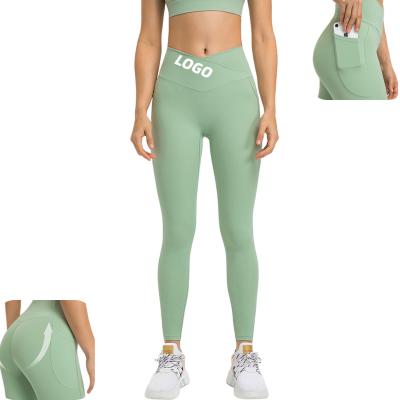 China Breathable New Cross Waist Sports Tights Women's Double Side Pockets High Elastic Hip Nine Point Yoga Pants For Ladies for sale