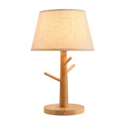 China Modern simple and modern Nordic warm fabric table lamps hotels bedroom solid wood decorative lighting fixture for sale