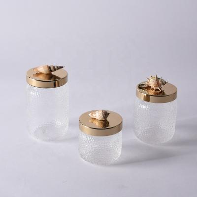 China Handcrafted Modern Home Decorative Glass White Home Decor Metal Table Pieces Conch Storage Conch Storage Gold Jar Tank for sale