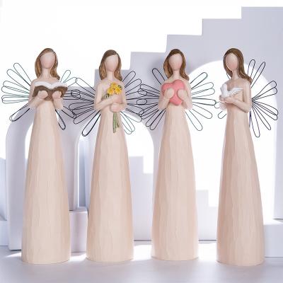 China Europe Abigail Factory Custom Religious Figures Resin Wood Carving Angel With Iron Wings Folk Crafts Office Home Decoration for sale