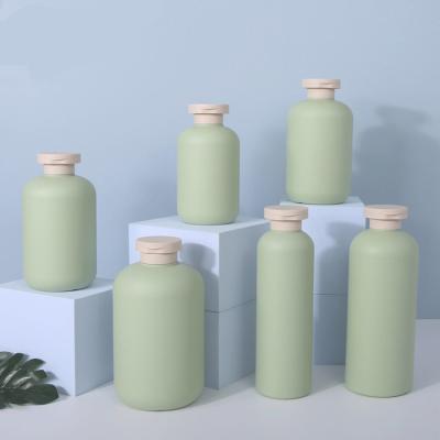 China Personal Care Products Cylindrical Green Shampoo Bottle Plastic Lotion 200ml 500ml Travel Set PE Material Bottles for sale