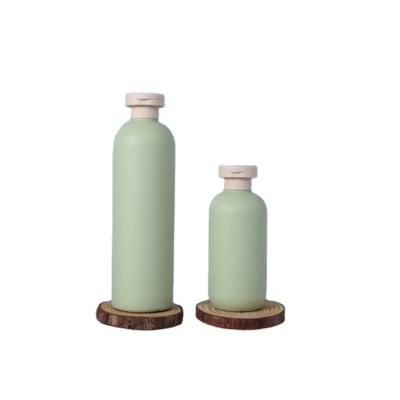 China Personal Care Products Single Cylindrical Green Lotion 200ml 500ml Shake Bottle Plastic Travel Set PE Material Bottles for sale