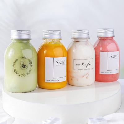 China Public Custom Small Plastic Juice Bottles Round Bottle Eco Friendly For Milk Tea Drink for sale