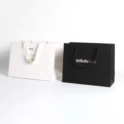 China Customizable Logo Paper Packaging Bags With Silk Ribbon Handle for sale