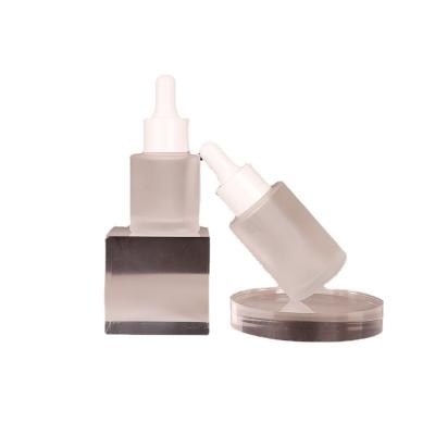 China Cosmetic Portable frosted glass plastic tip dropper 50ml cosmetics bottles for sale