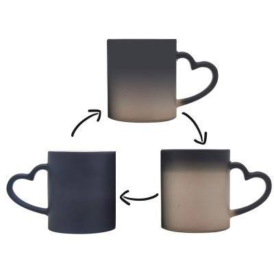 China Viable Black Heat Sensitive Coated Sublimation Ceramic Mug Color Changing Mug With Heart Handle for sale