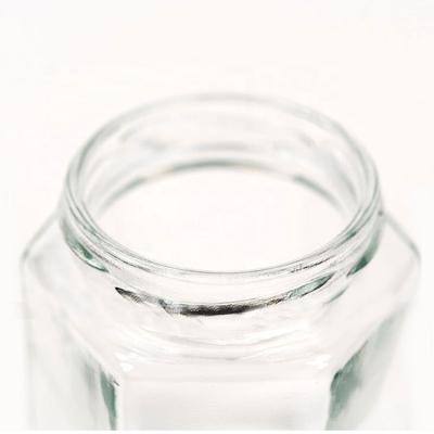 China Viable Empty Flat Hexagon Jam Jar Honey Jar Glass Food Jar 280ml Transparent Glass Bottle for sale