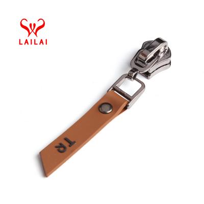 China Free sample factory low price nickel free custom make any logo long zipper pulls leather bag zipper puller slider for garment accessories for sale