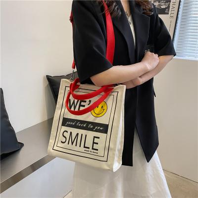 China 2023 Leisure 2023 Messenger Bag Fashion Design Korean Version Portable Sense Large Capacity Portable Face Canvas Smile Bag for sale