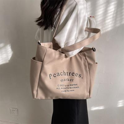 China 2023 portable new tide letter Tote Bag High Capacity Canvas a cross - body tide bag for sale