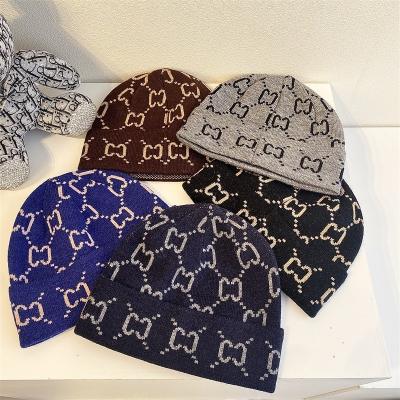 China COMMON Knitted Outdoor Warm Woolen Hat Fashion Street Hearing Protection Hat Alphabet Hat Men for sale