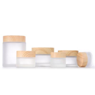 China Personal Care Frosted Empty Glass Bottles Cosmetic Jar Cream Bottle With Wood Grain Lid 5g/10g/15g/30g/50g Eye Cream Face Cream Bottle for sale