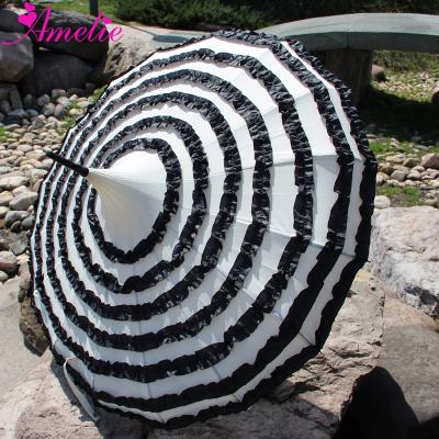 China Lady Promotion Model Fashion Design Straight Black With Twist Pagoda Sunshade Ivory Umbrella for sale