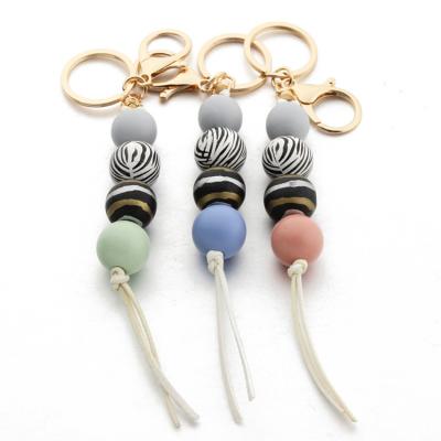 China Promotion Zooying gift 2021 leopard pattern hot sale summer wooden bead tassel keychains for sale