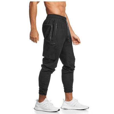 China Custom Anti-Wrinkle Back OEM Logo Design Zipper Pocket Cargo Pants Loop Lightweight Stretch Cargo Jogger For Men for sale