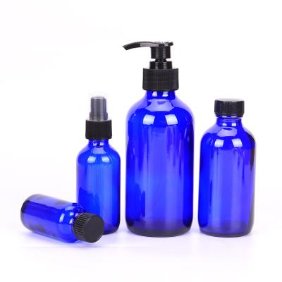 China Personal Care Boston Serum Bottle Essential Oil Blue Round Glass Packaging With Dropper Cap for sale