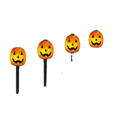 China Hot Sale Outdoor Halloween Pumpkin White Set of 4 Solar Pre-Lit Jack-O-Lanterns Pathway Markers Stakes Waterproof Pathway Lights for sale