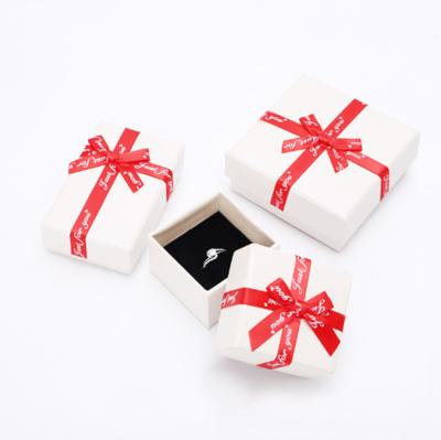 China Recycled Materials Jewelry Box Earrings&Ring Packaging White Kraft Paper Box With Red Bow for sale