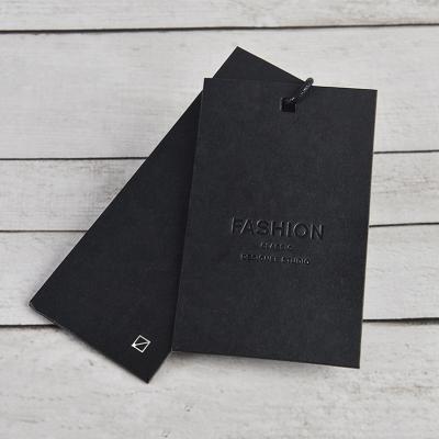 China Durable Garment Apparel Custom UV Printing Embossed Card Black Paper Hang Tag for sale